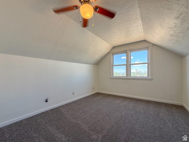 346 Columbia Dr, East Carbon, UT 84520 - bonus room featuring a textured ceiling, baseboards, vaulted ceiling, dark carpet, and ceiling fan