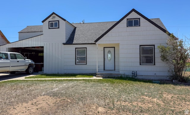 346 Columbia Dr, East Carbon, UT 84520 - view of front of property featuring a shingled roof, a garage, board and batten siding, and a front lawn