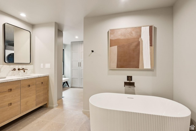 2655 E Hiawatha Cir, Salt Lake City, UT 84108 - bathroom with recessed lighting, vanity, a freestanding bath, and baseboards