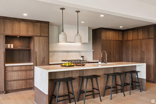 2655 E Hiawatha Cir, Salt Lake City, UT 84108 - kitchen featuring modern cabinets, a sink, light countertops, light wood-type flooring, and recessed lighting