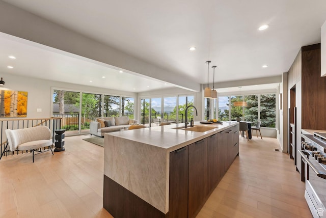 2655 E Hiawatha Cir, Salt Lake City, UT 84108 - kitchen featuring a sink, modern cabinets, high end stainless steel range oven, a large island, and light wood finished floors