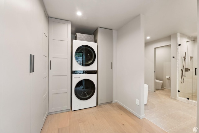 2655 E Hiawatha Cir, Salt Lake City, UT 84108 - washroom featuring estacked washer and dryer, baseboards, recessed lighting, and light wood-style flooring
