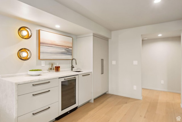 2655 E Hiawatha Cir, Salt Lake City, UT 84108 - kitchen featuring beverage cooler, recessed lighting, light wood-style flooring, white cabinetry, and light countertops