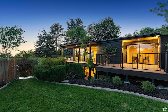 2655 E Hiawatha Cir, Salt Lake City, UT 84108 - back of house at dusk featuring a deck