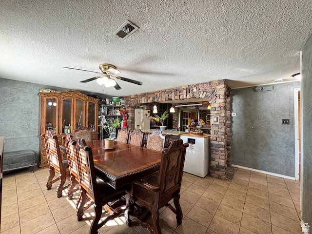 1204 S Redwood Dr, Salt Lake City, UT 84104 - dining area featuring light tile patterned floors, ceiling fan, and a textured ceiling