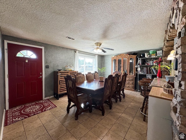 1204 S Redwood Dr, Salt Lake City, UT 84104 - dining space with ceiling fan, light tile patterned floors, and a textured ceiling