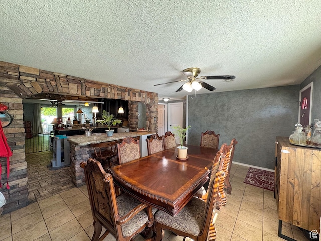 1204 S Redwood Dr, Salt Lake City, UT 84104 - dining space featuring a textured ceiling, ceiling fan, light tile patterned floors, and bar area
