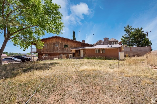785 N Lauritzen St, Hildale, UT 84784 - rear view of property featuring a chimney