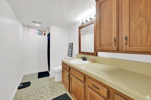 2195 W 4250 S, Roy, UT 84067 - bathroom featuring vanity, toilet, a textured ceiling, baseboards, and curtained shower