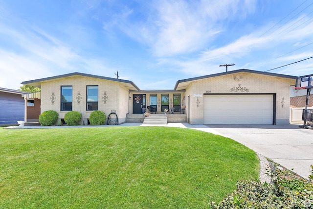 2195 W 4250 S, Roy, UT 84067 - ranch-style house with brick siding, an attached garage, a front lawn, and concrete driveway
