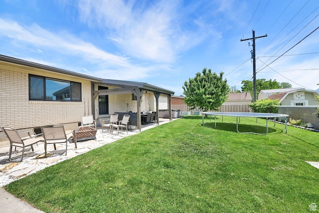 2195 W 4250 S, Roy, UT 84067 - view of yard with an outdoor fire pit, a trampoline, and a patio