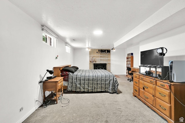 2195 W 4250 S, Roy, UT 84067 - bedroom featuring light colored carpet, baseboards, a fireplace, and a textured ceiling