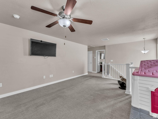 5636 W Lost Mine Ln, Herriman, UT 84096 - unfurnished living room featuring a ceiling fan, carpet floors, a textured ceiling, and baseboards