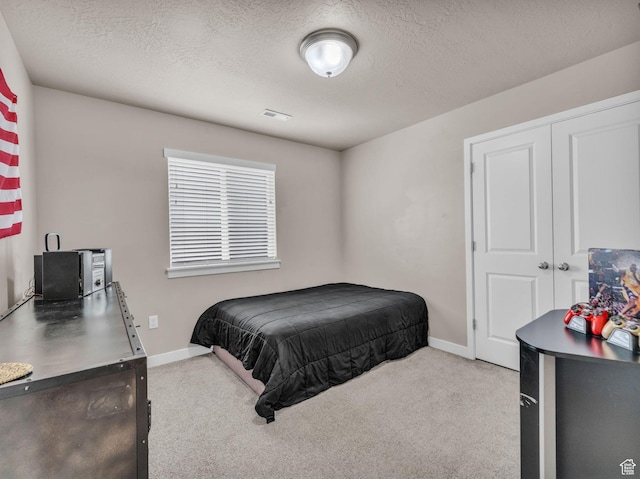 5636 W Lost Mine Ln, Herriman, UT 84096 - carpeted bedroom featuring baseboards, a textured ceiling, and a closet