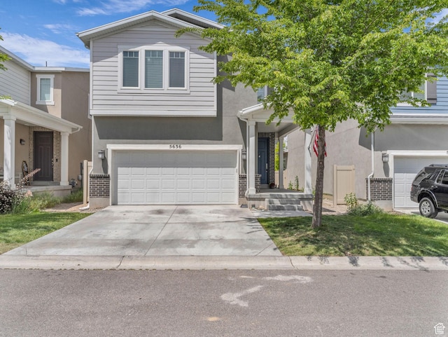 5636 W Lost Mine Ln, Herriman, UT 84096 - view of front of property with a garage, stucco siding, and driveway