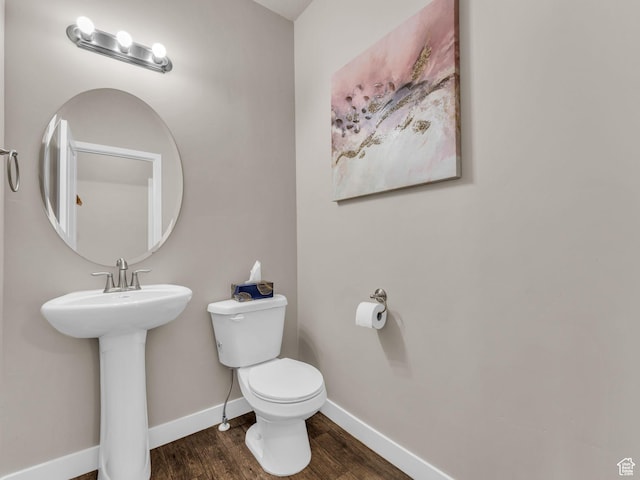 5636 W Lost Mine Ln, Herriman, UT 84096 - half bath with toilet, wood finished floors, baseboards, and a sink