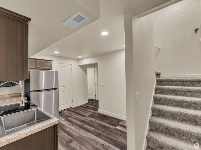 5636 W Lost Mine Ln, Herriman, UT 84096 - kitchen featuring freestanding refrigerator, dark wood-type flooring, recessed lighting, a sink, and dark brown cabinets
