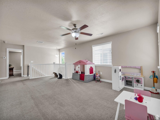 5636 W Lost Mine Ln, Herriman, UT 84096 - rec room featuring a ceiling fan, a textured ceiling, baseboards, and carpet floors