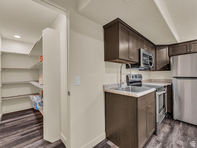 5636 W Lost Mine Ln, Herriman, UT 84096 - kitchen featuring stainless steel appliances, dark brown cabinetry, light countertops, and dark wood-type flooring