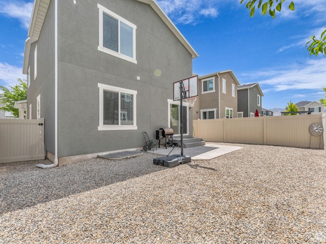 5636 W Lost Mine Ln, Herriman, UT 84096 - rear view of house with a patio and stucco siding