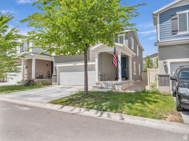 5636 W Lost Mine Ln, Herriman, UT 84096 - view of front of house featuring a garage, concrete driveway, and stucco siding