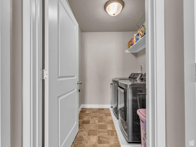 5636 W Lost Mine Ln, Herriman, UT 84096 - washroom featuring washing machine and dryer, a textured ceiling, and baseboards