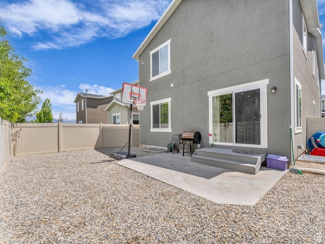 5636 W Lost Mine Ln, Herriman, UT 84096 - rear view of house featuring a fenced backyard, stucco siding, and a patio