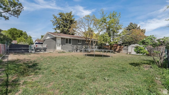 1951 W 7125 S, West Jordan, UT 84084 - back of house with a trampoline and brick siding