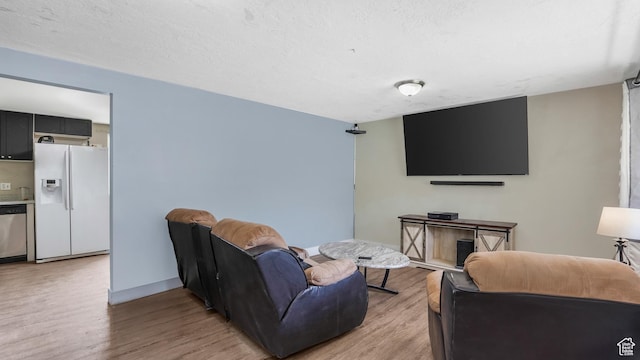 1951 W 7125 S, West Jordan, UT 84084 - living area with light wood-style floors, baseboards, and a textured ceiling