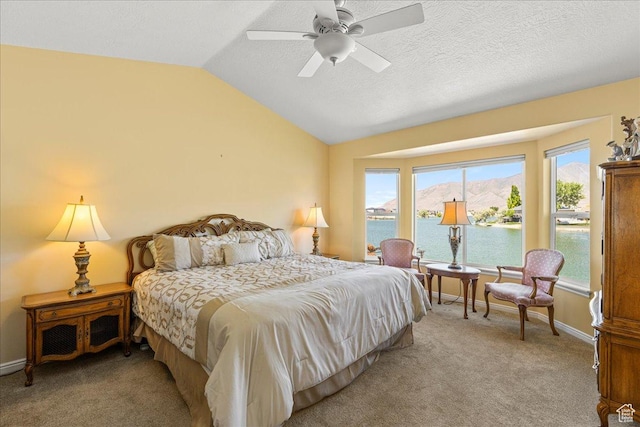 6142 N Schooner Ln, Stansbury Park, UT 84074 - carpeted bedroom with lofted ceiling, a water view, multiple windows, a ceiling fan, and baseboards