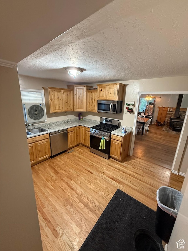 239 W Plum St, Grantsville, UT 84029 - kitchen featuring stainless steel appliances, a sink, light wood-style floors, light countertops, and a textured ceiling