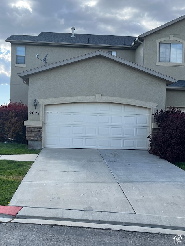 2027 W 2175 N, Lehi, UT 84043 - view of home's exterior with concrete driveway, stucco siding, and a garage