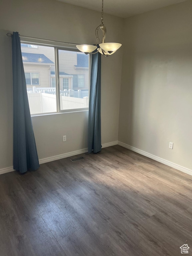 2027 W 2175 N, Lehi, UT 84043 - empty room featuring a chandelier, dark wood finished floors, and baseboards