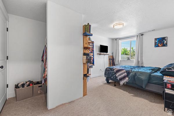 1024 E 1300 S Unit 31, Provo, UT 84606 - bedroom featuring carpet floors, a textured ceiling, and baseboards