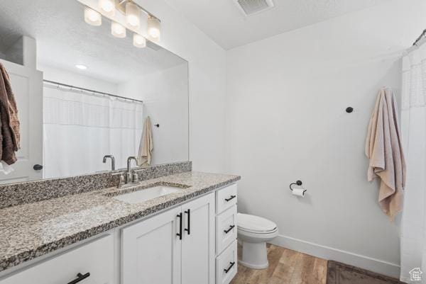 1024 E 1300 S Unit 31, Provo, UT 84606 - bathroom featuring vanity, toilet, wood finished floors, baseboards, and a shower with curtain
