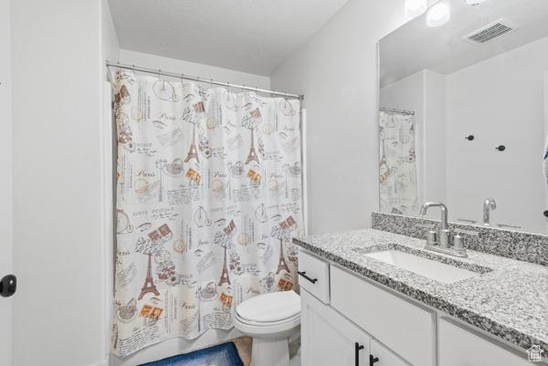 1024 E 1300 S Unit 31, Provo, UT 84606 - full bathroom with vanity, toilet, and a shower with shower curtain