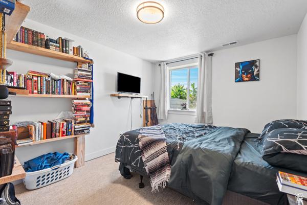 1024 E 1300 S Unit 31, Provo, UT 84606 - carpeted bedroom featuring a textured ceiling