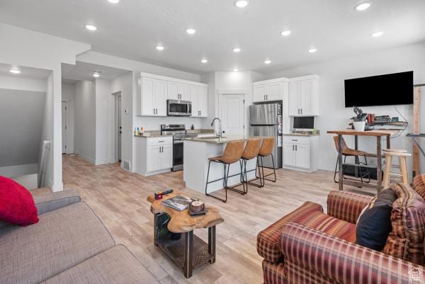 1024 E 1300 S Unit 31, Provo, UT 84606 - living area featuring recessed lighting, light wood-style floors, and baseboards