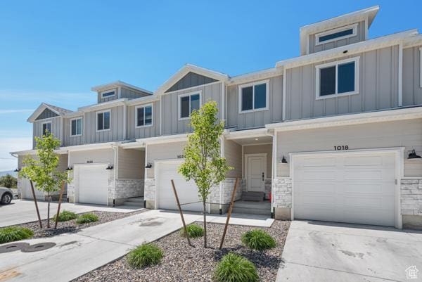 1024 E 1300 S Unit 31, Provo, UT 84606 - view of property featuring board and batten siding, an attached garage, and stone siding