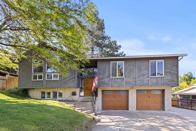 720 Freedom Cir N, Salt Lake, UT 84054 - bi-level home with driveway, brick siding, and an attached garage