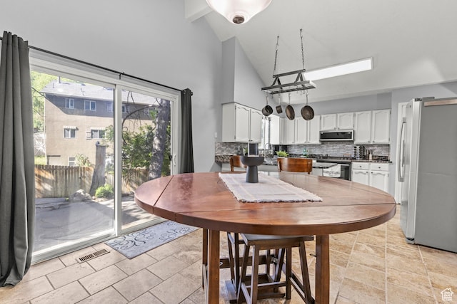 720 Freedom Cir N, Salt Lake, UT 84054 - dining room featuring high vaulted ceiling and light stone finish floors