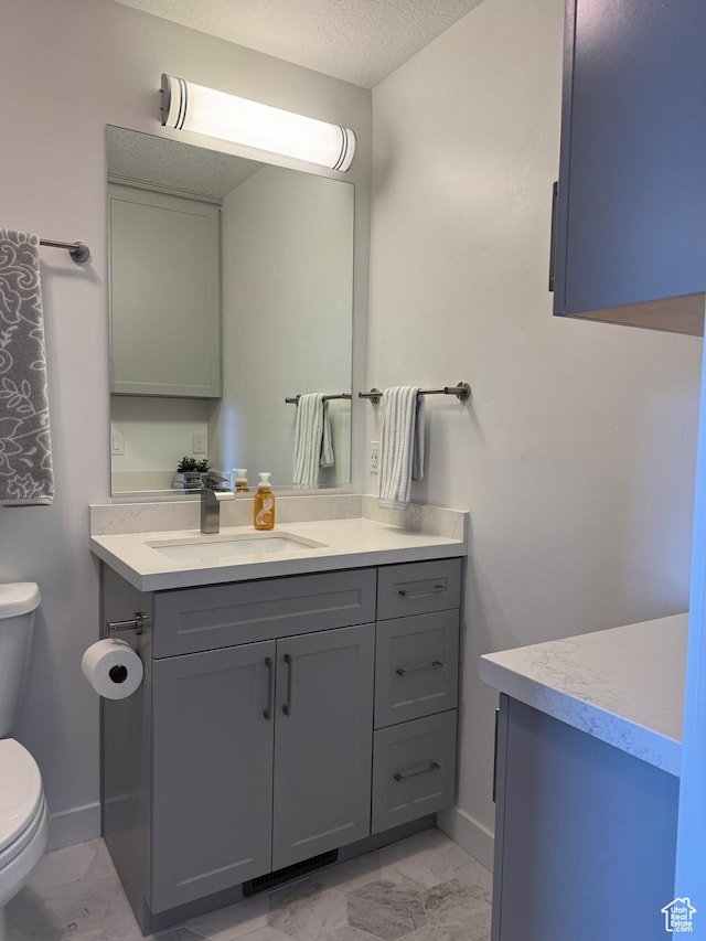 5308 W Solafax Ln S, Herriman, UT 84096 - bathroom featuring marble finish floors, vanity, and a textured ceiling