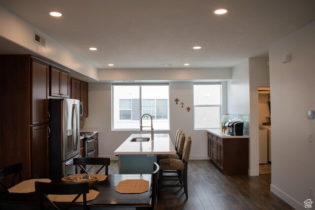 5308 W Solafax Ln S, Herriman, UT 84096 - kitchen with stainless steel appliances, light countertops, recessed lighting, an island with sink, and dark wood-style flooring