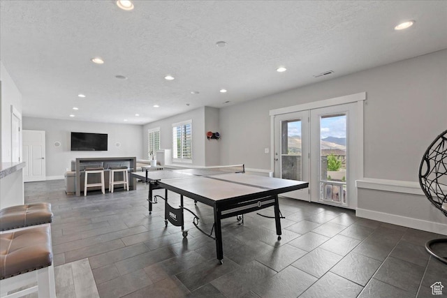 6688 W Buck Dr, Herriman, UT 84096 - playroom featuring recessed lighting, french doors, a textured ceiling, and baseboards