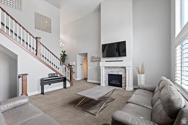 6688 W Buck Dr, Herriman, UT 84096 - living room featuring a towering ceiling, stairway, carpet, baseboards, and a stone fireplace