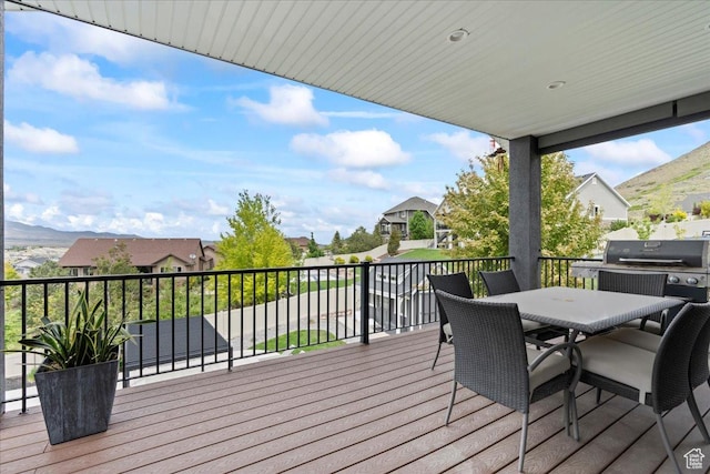 6688 W Buck Dr, Herriman, UT 84096 - wooden deck featuring area for grilling, outdoor dining space, a mountain view, and a residential view