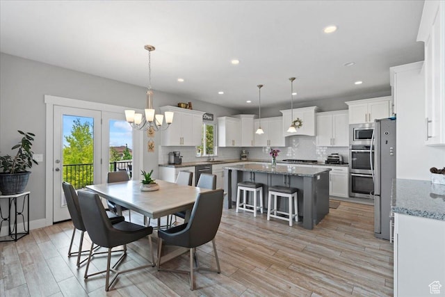 6688 W Buck Dr, Herriman, UT 84096 - dining room with a chandelier, light wood-style flooring, and recessed lighting