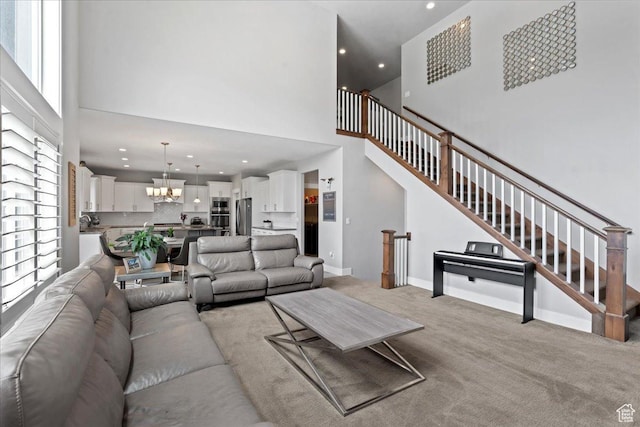 6688 W Buck Dr, Herriman, UT 84096 - living area featuring a high ceiling, a chandelier, light colored carpet, recessed lighting, and stairway
