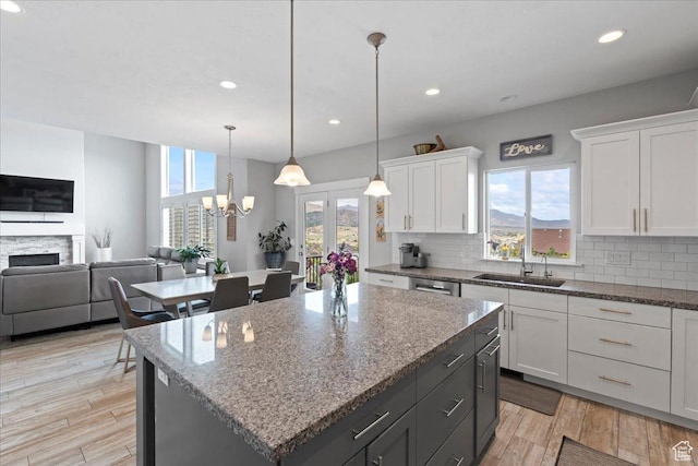 6688 W Buck Dr, Herriman, UT 84096 - kitchen with a sink, open floor plan, backsplash, white cabinets, and recessed lighting