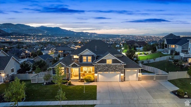 6688 W Buck Dr, Herriman, UT 84096 - craftsman-style home with stone siding, concrete driveway, a mountain view, a gate, and a residential view